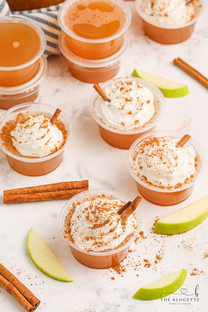 Apple Pie Jello Shots made with Fireball! Topped with whipped cream, this festive jello shot is well-balanced for the holidays or any fall gathering!