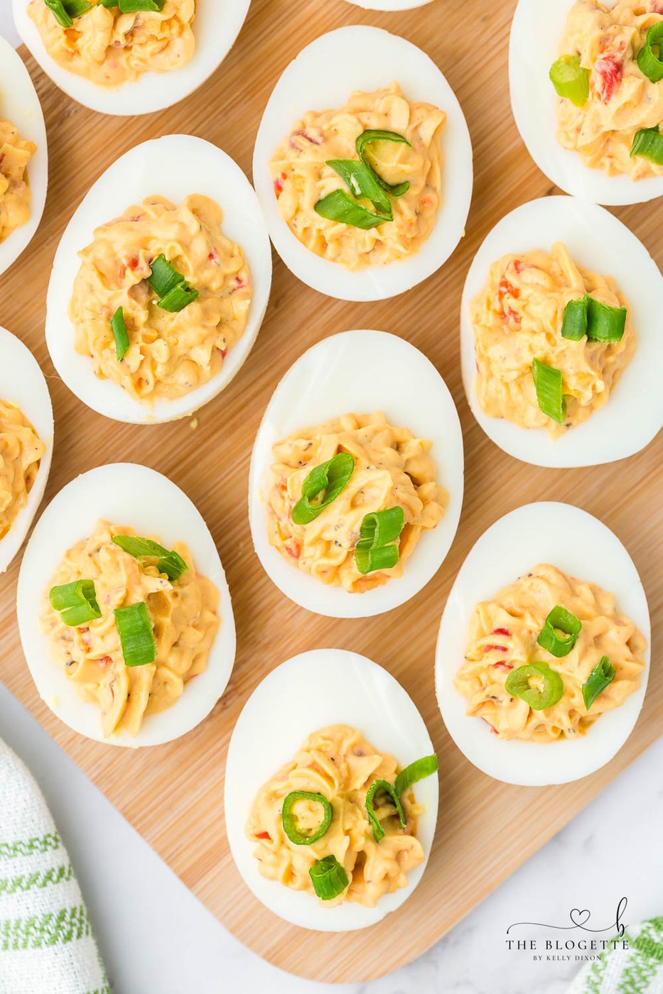 Bacon Pimento Deviled Eggs Recipe - Delicately displayed egg whites filled with a creamy pimento cheese mixture and topped with bacon!