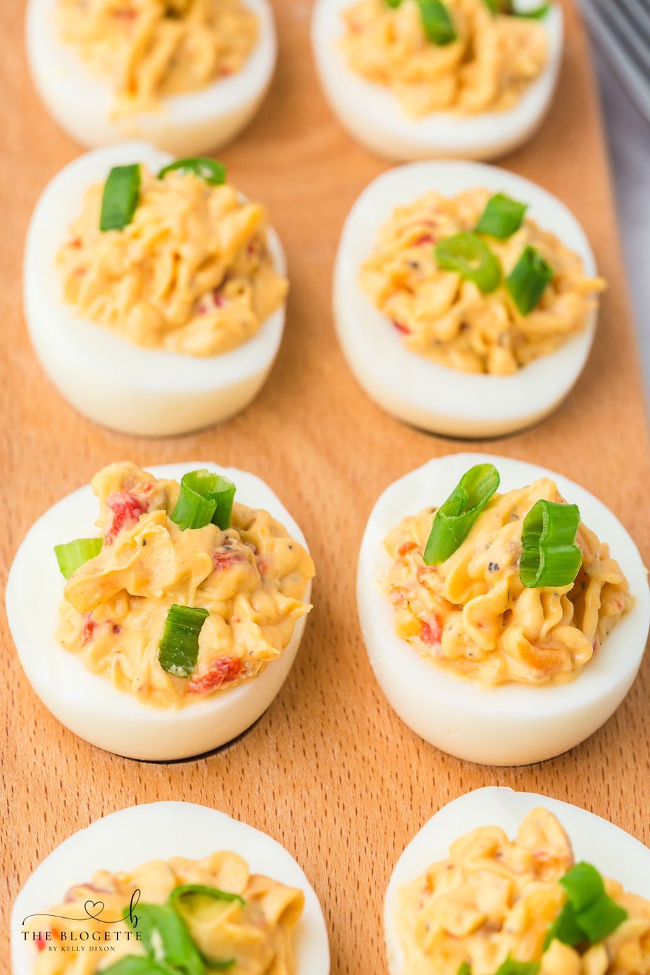 Bacon Pimento Deviled Eggs Recipe - Delicately displayed egg whites filled with a creamy pimento cheese mixture and topped with bacon!