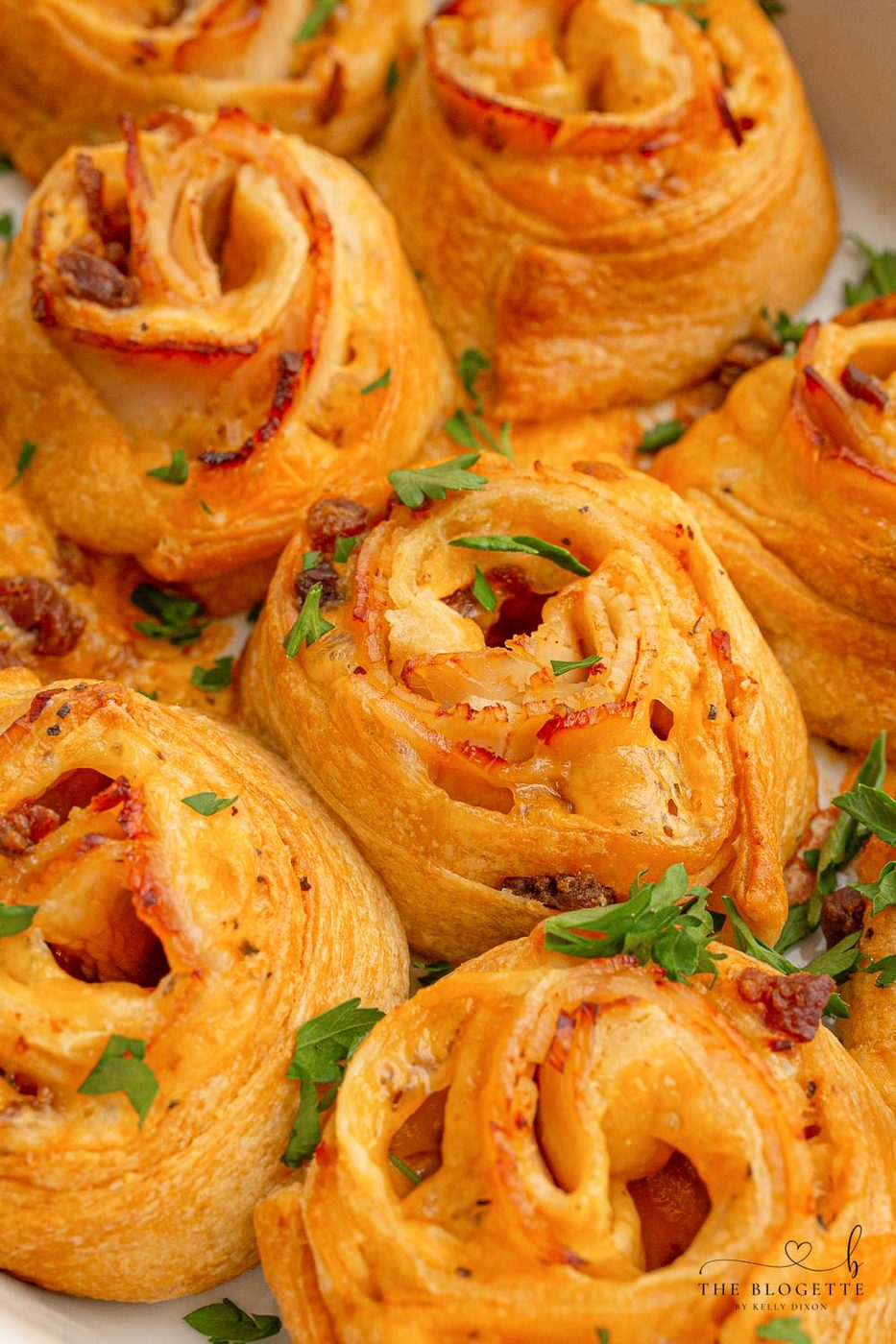 Baked Turkey and Cheese Rolls have melted cheese, bacon, and turkey covered in a garlic buttery glaze! The well-balanced party appetizer idea!