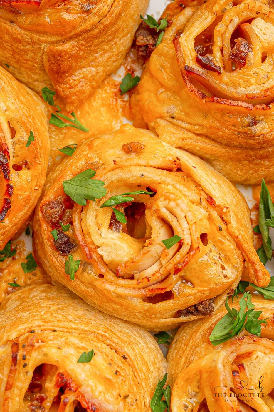 Baked Turkey and Cheese Rolls have melted cheese, bacon, and turkey covered in a garlic buttery glaze! The well-balanced party appetizer idea!