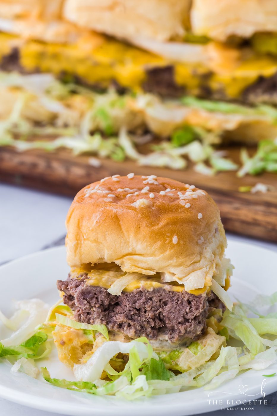 stacked burger Sliders are the miniature version of your favorite fast food burger! Juicy little hamburgers with pickles, onions, lettuce, the "secret sauce", and then surrounded by buttery buns.