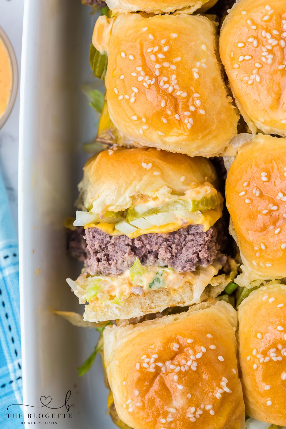 stacked burger Sliders are the miniature version of your favorite fast food burger! Juicy little hamburgers with pickles, onions, lettuce, the "secret sauce", and then surrounded by buttery buns.