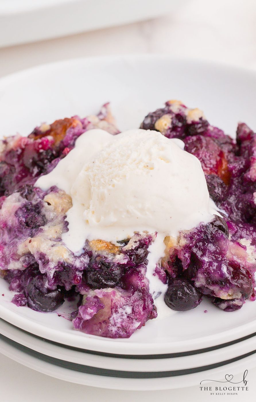 Blueberry Cobbler is a satisfying and straightforward recipe to use with all of those summer blueberries! It's a speedy and straightforward dessert topped with a scoop of vanilla ice cream.