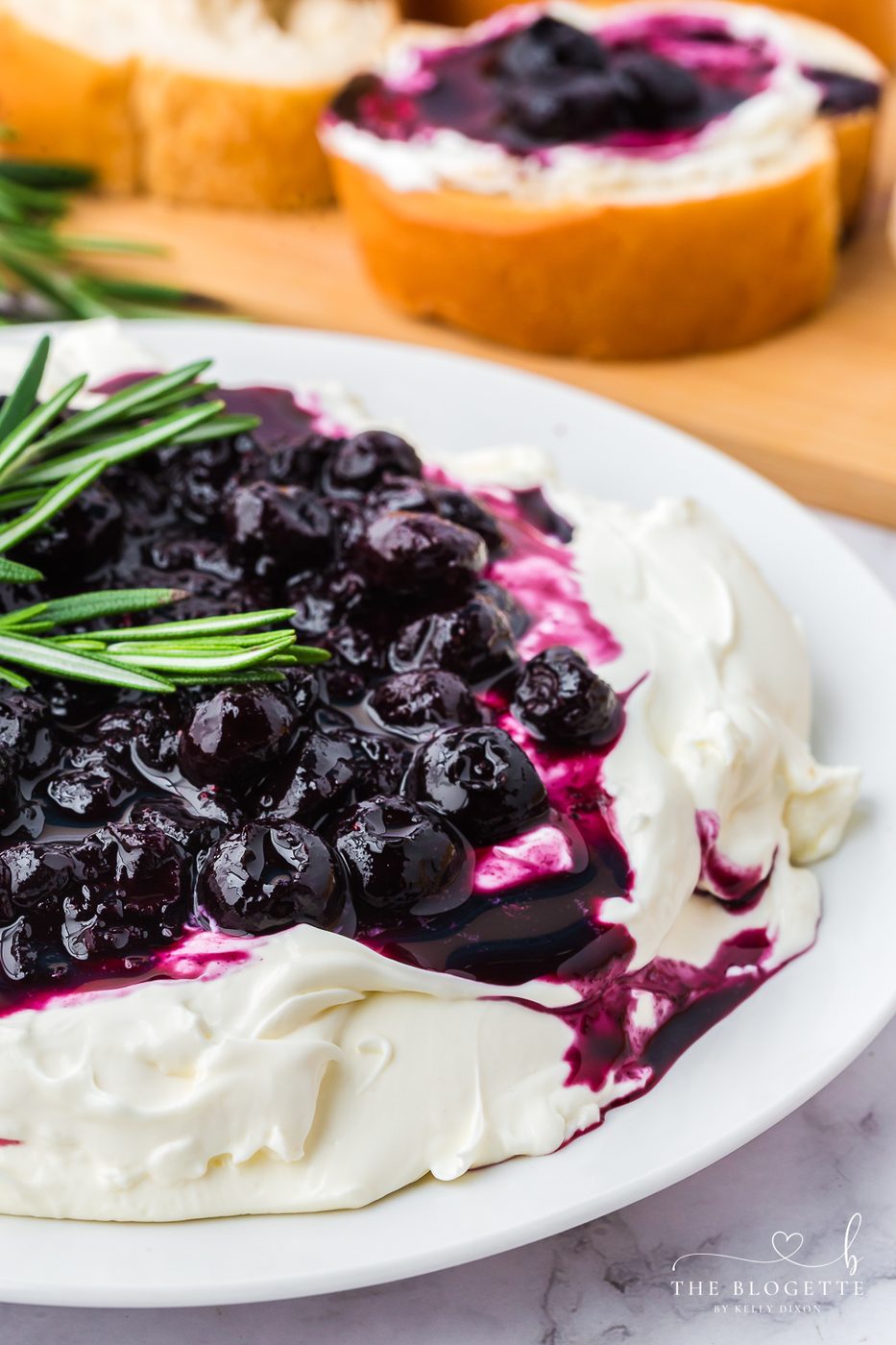 This Blueberry Goat Cheese Dip appetizer is a beautiful and straightforward 10-minute recipe served with slices of French bread.