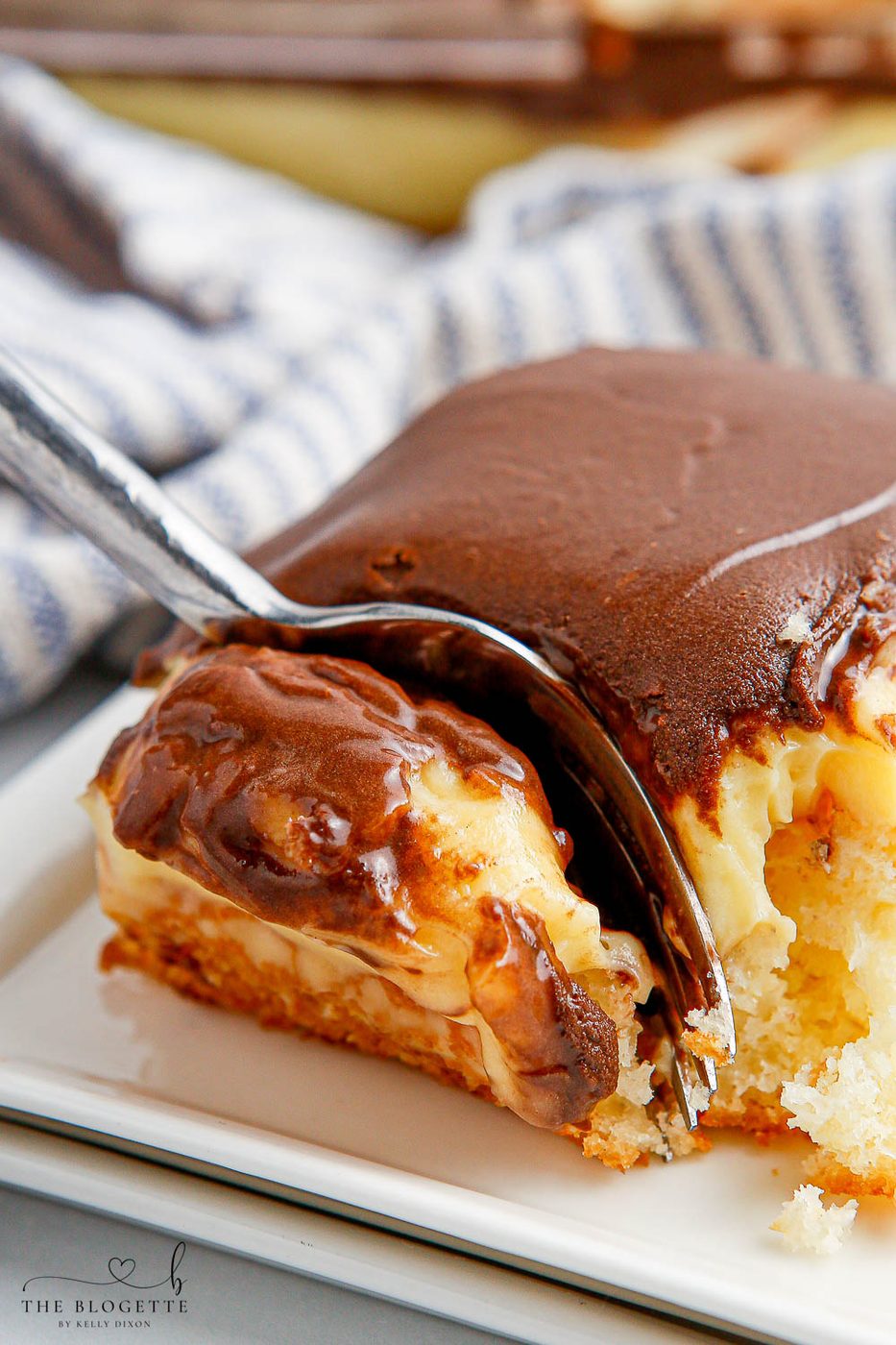 Boston Cream Poke Cake is so simple to whip up. With cake, pudding, and chocolate frosting, this cake is a speedy spin on Boston Cream Pie!