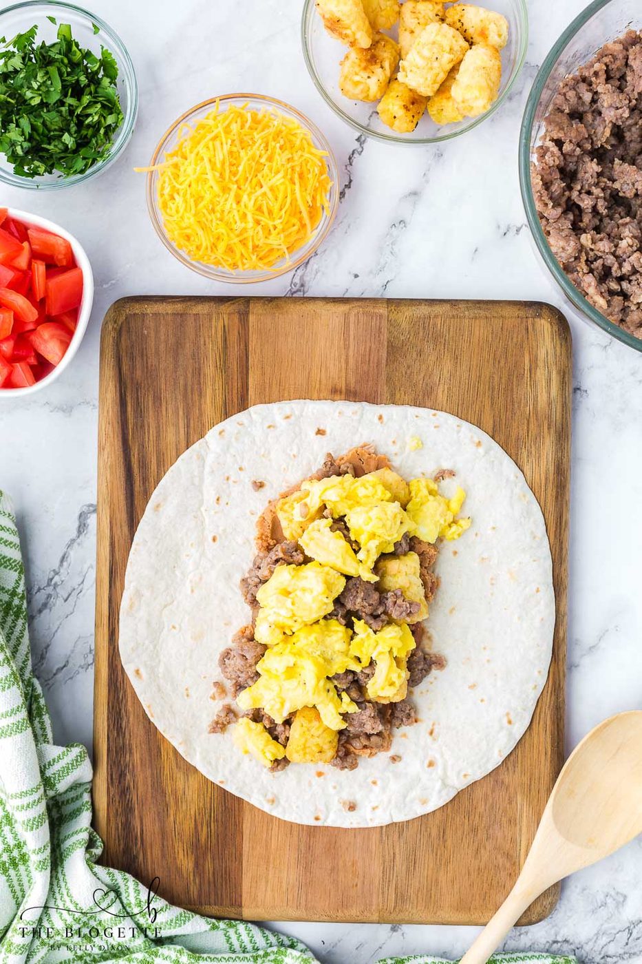 Tortillas, beans, eggs, meat, and tater tots