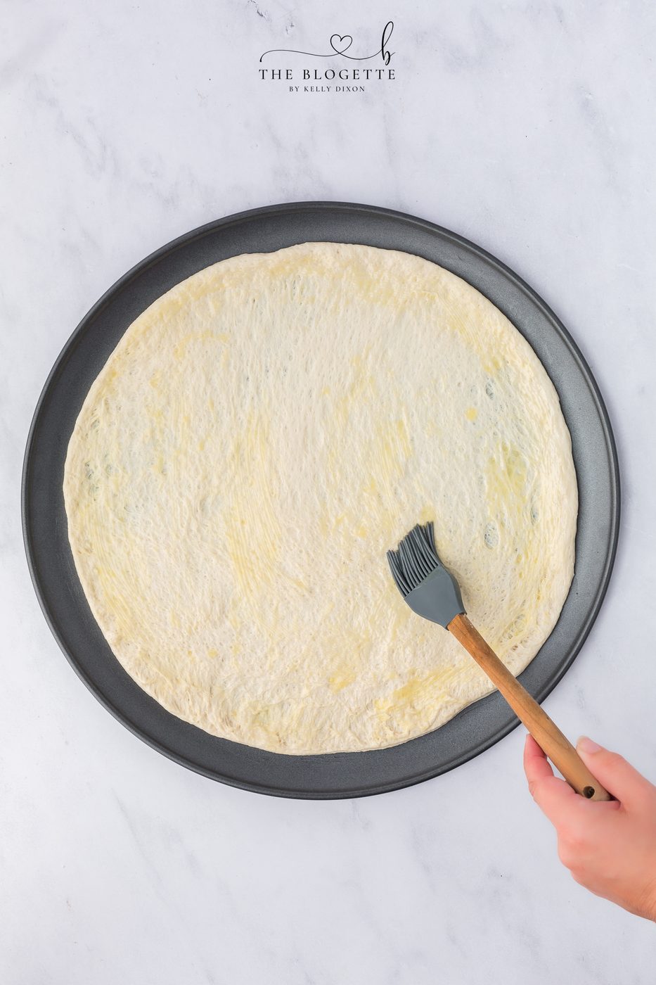 Roll out pizza crust and brush with melted butter