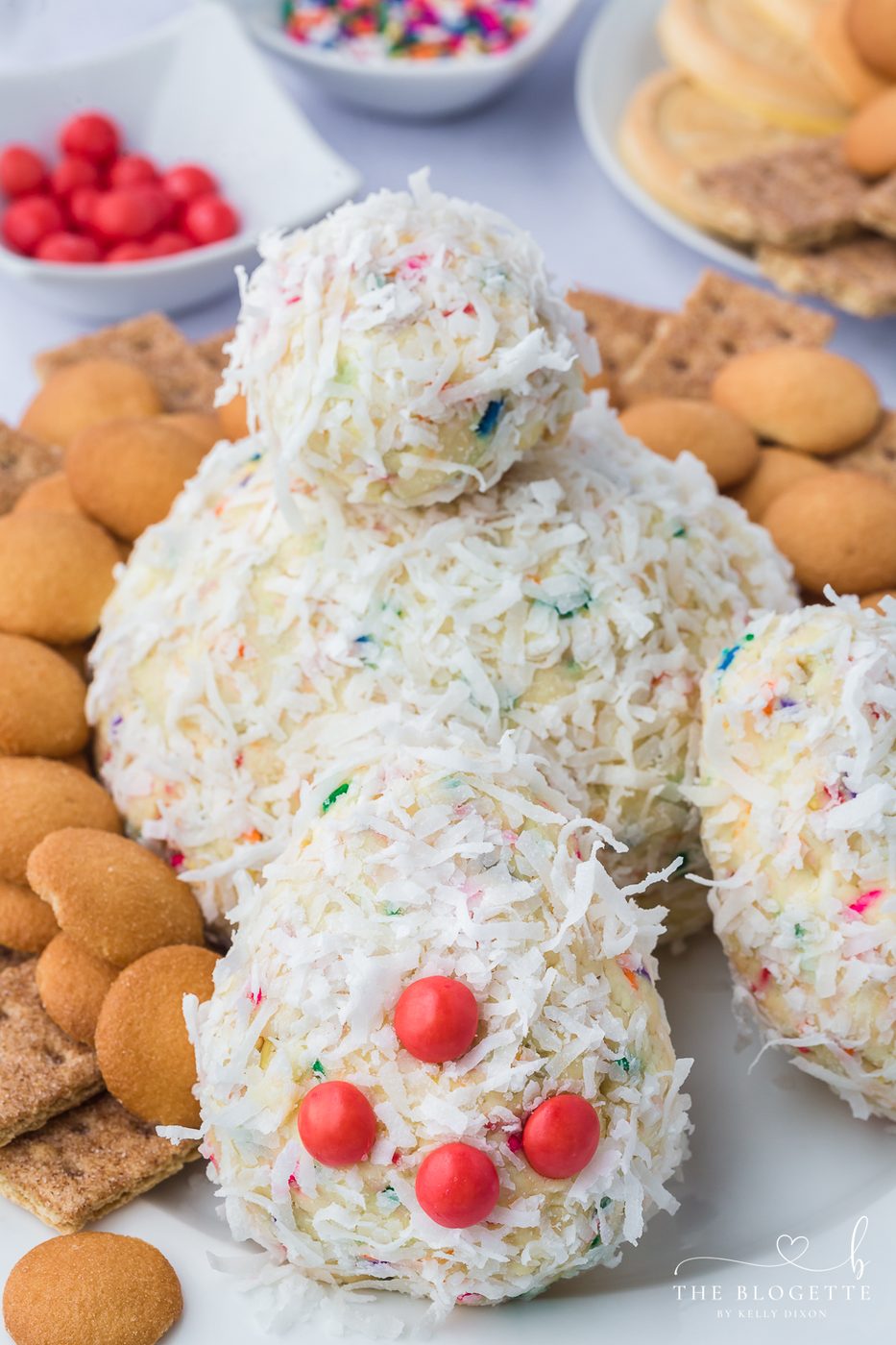 A Bunny Butt Cheeseball that is both whimsical and satisfying! Made with cream cheese, sprinkles, and fluffy layer of shredded coconut.