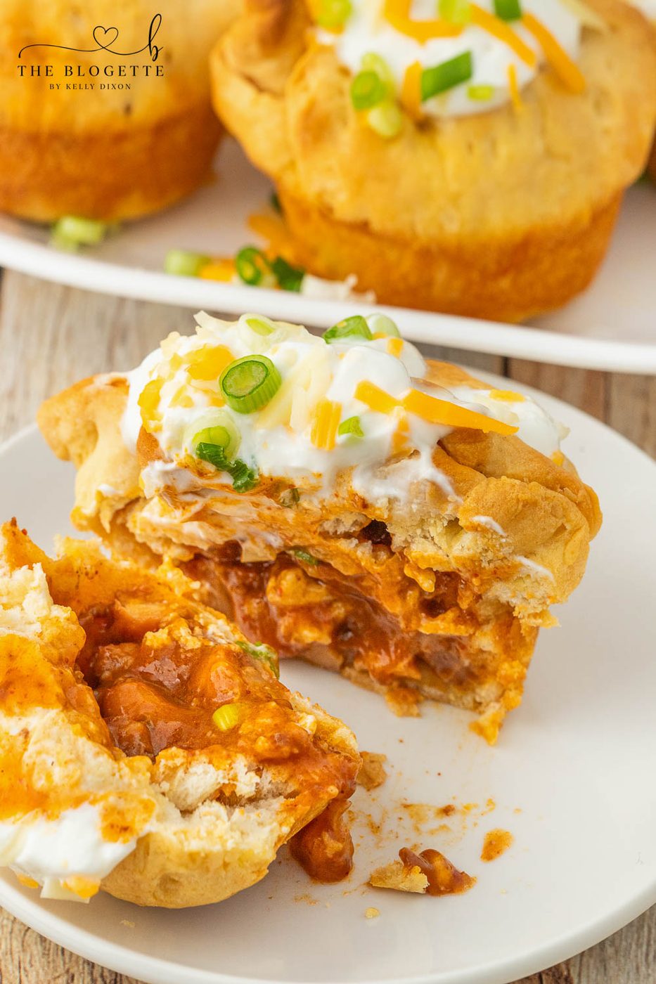 Chili stuffed rolls! Buttery biscuits surrounding chili and cheese, topped with sour cream and green onions.
