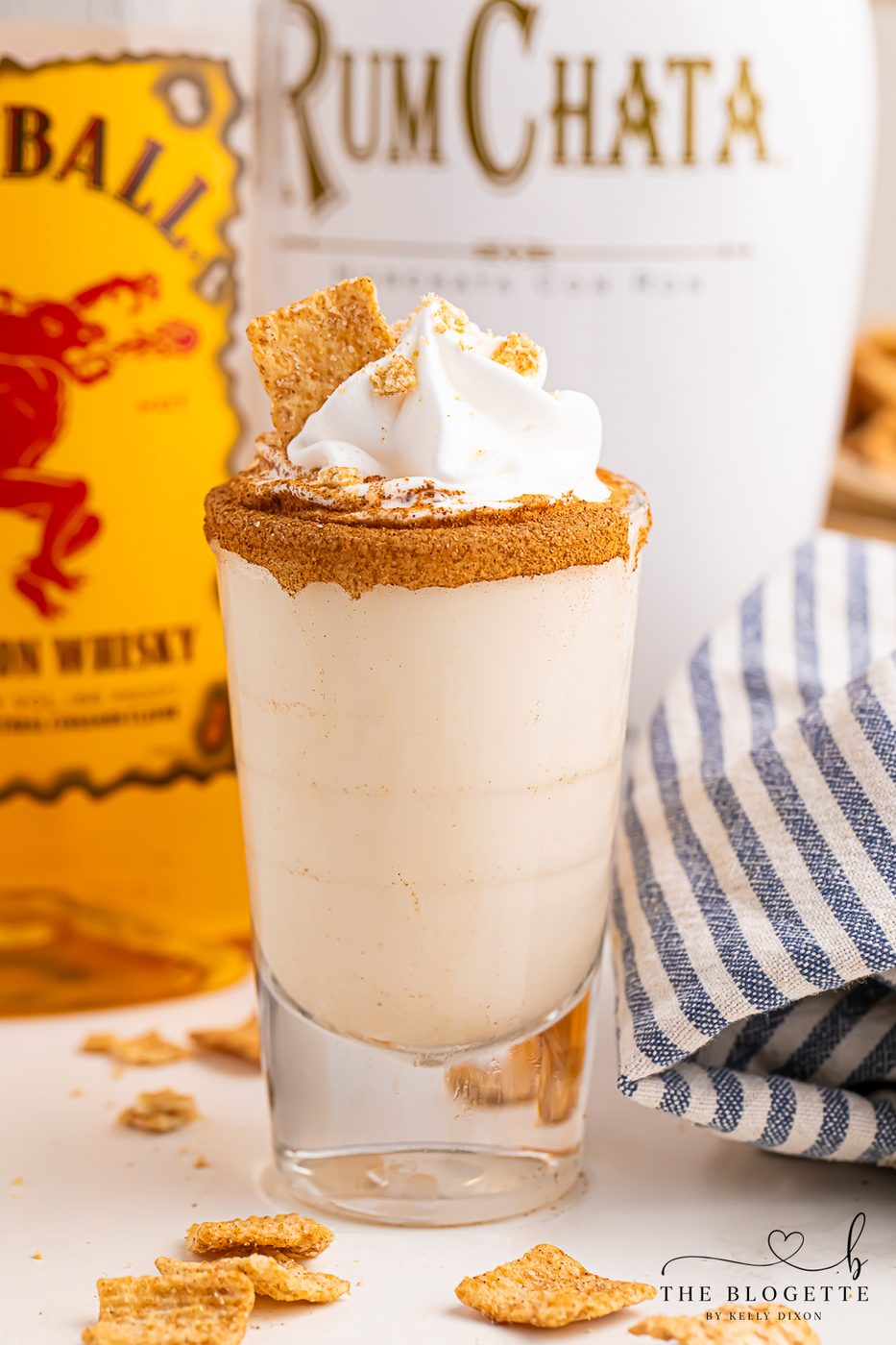 Cinnamon Toast Shots are a fun and festive mix of rum and whiskey! A rich and sweet cereal inspired drink topped with whipped cream.