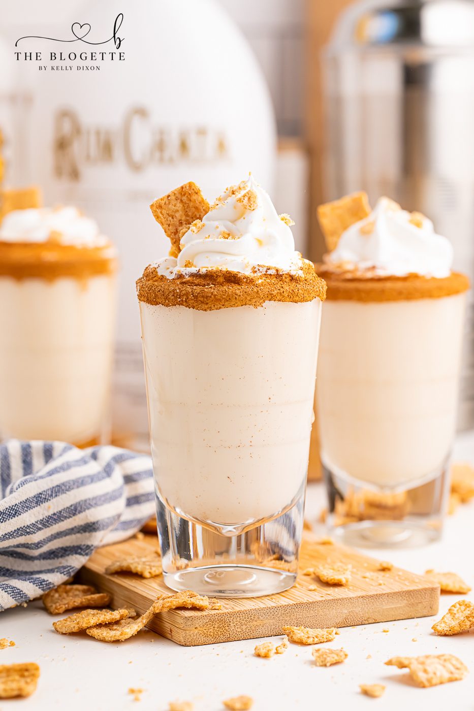 Cinnamon Toast Shots are a fun and festive mix of rum and whiskey! A rich and sweet cereal inspired drink topped with whipped cream.