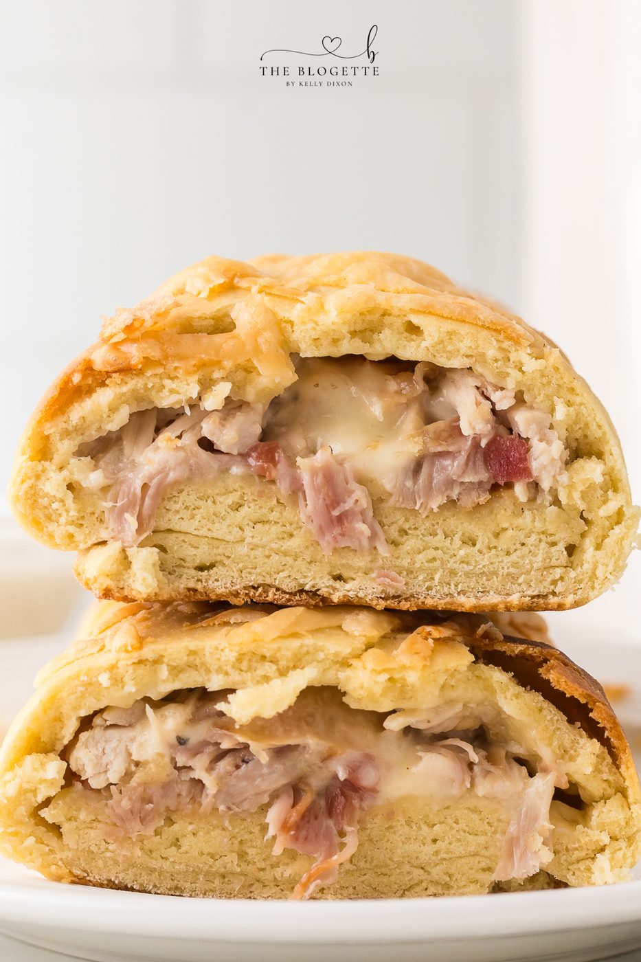 How to make a Costco Chicken Bake at home! Fluffy dough wrapped around chicken, cheese, and bacon and drizzled with Caesar dressing.