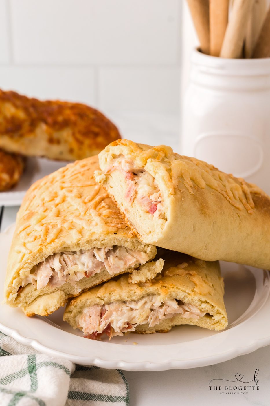 How to make a Costco Chicken Bake at home! Fluffy dough wrapped around chicken, cheese, and bacon and drizzled with Caesar dressing.