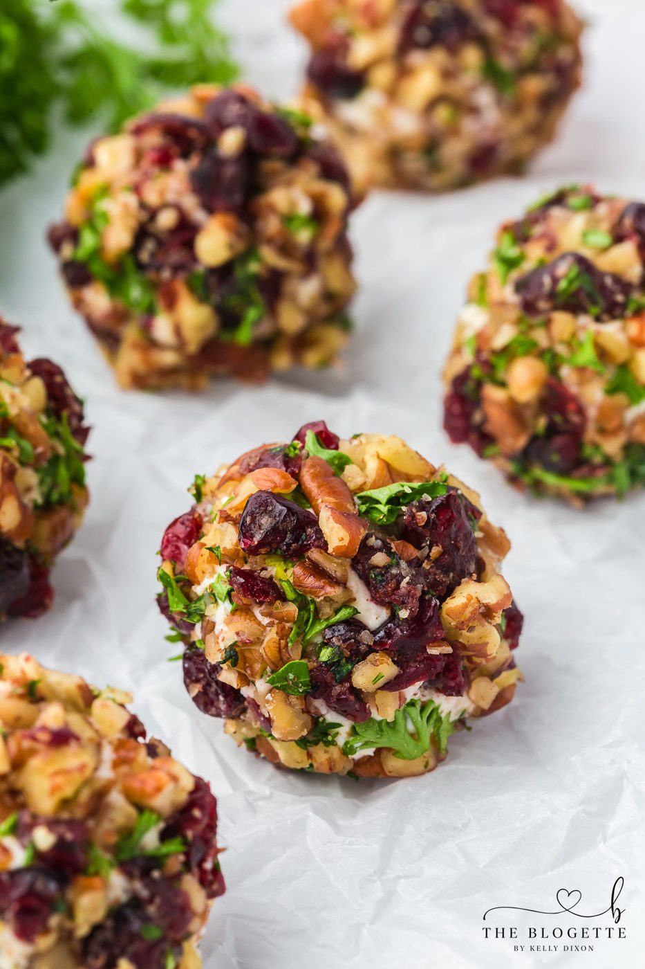 Cranberry Pecan Goat Cheese Balls are festive mini cheese truffles loaded with creamy goat cheese, sweet cranberries, and crisp pecans!