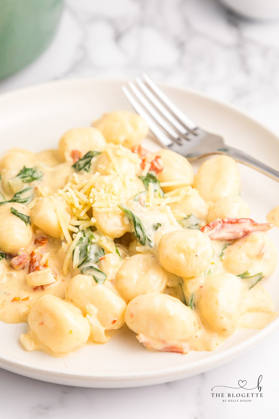 Creamy Tuscan Gnocchi - Soft gnocchi cooked in a cream sauce with sun-dried tomatoes, spinach, and garlic. Done in just 20 minutes!