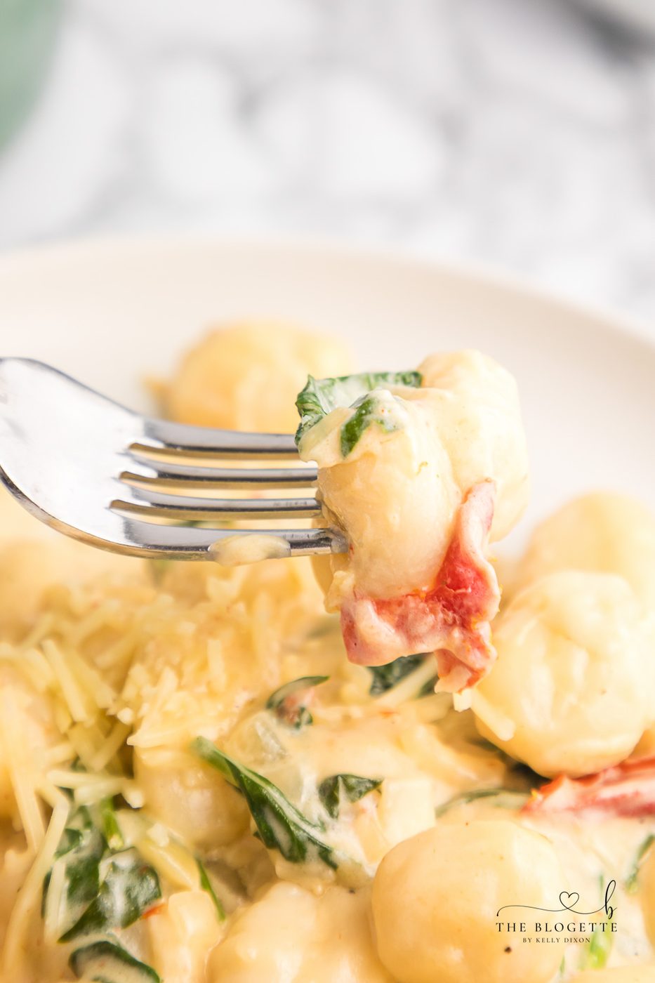 Creamy Tuscan Gnocchi - Soft gnocchi cooked in a cream sauce with sun-dried tomatoes, spinach, and garlic. Done in just 20 minutes!