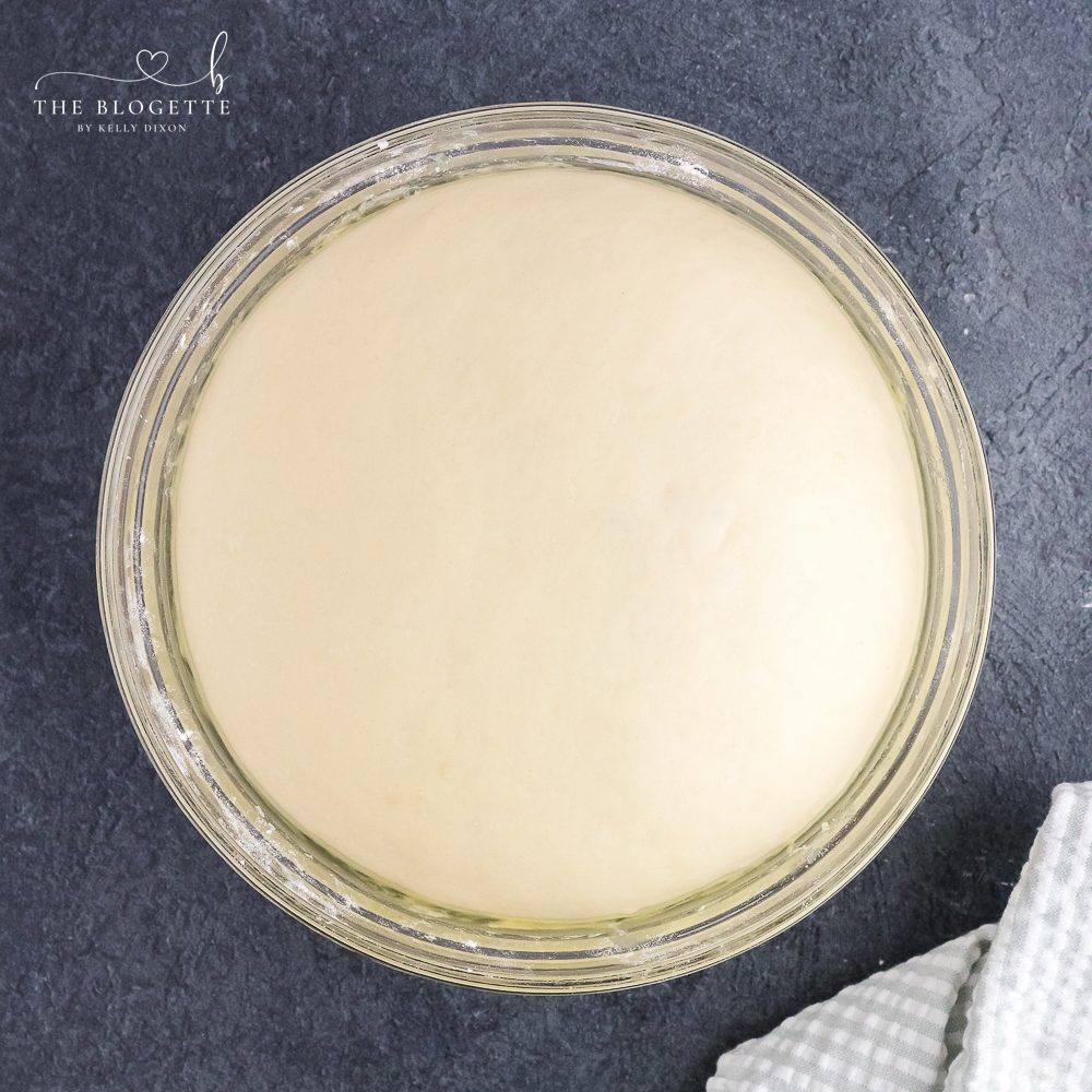 When dough has doubled in size, punch down the dough and turn out into a lightly floured surface.