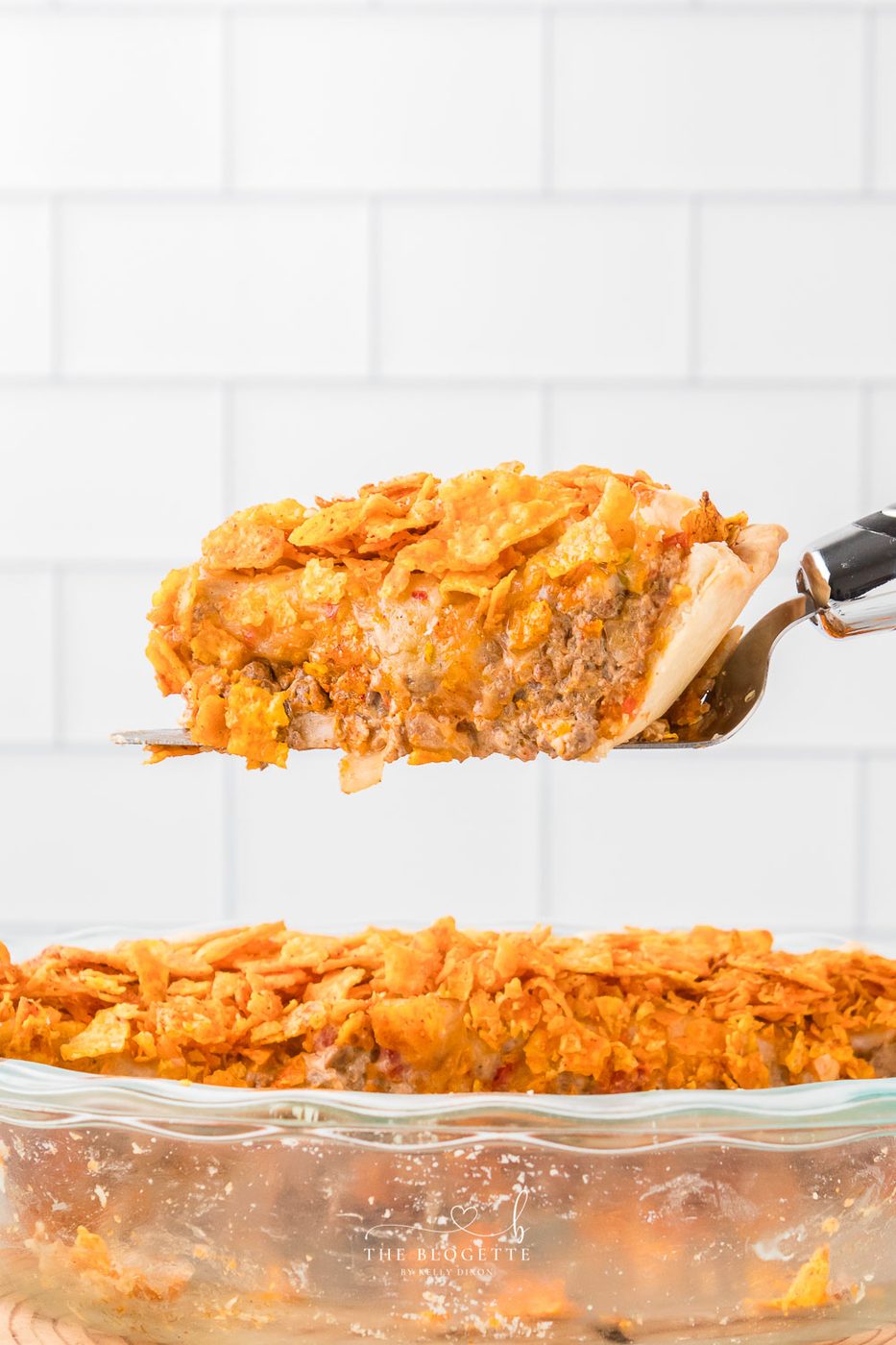 This Straightforward Dorito Pie Recipe is made with a pie crust, ground beef, Cool Ranch or Nacho Cheese Doritos, and a creamy cheese sauce!