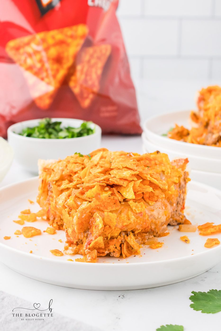 This Straightforward Dorito Pie Recipe is made with a pie crust, ground beef, Cool Ranch or Nacho Cheese Doritos, and a creamy cheese sauce!