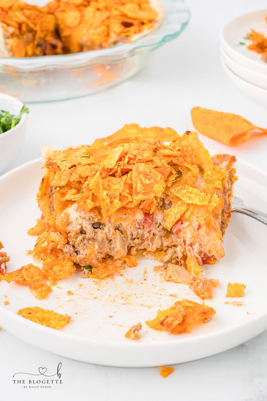 This Straightforward Dorito Pie Recipe is made with a pie crust, ground beef, Cool Ranch or Nacho Cheese Doritos, and a creamy cheese sauce!