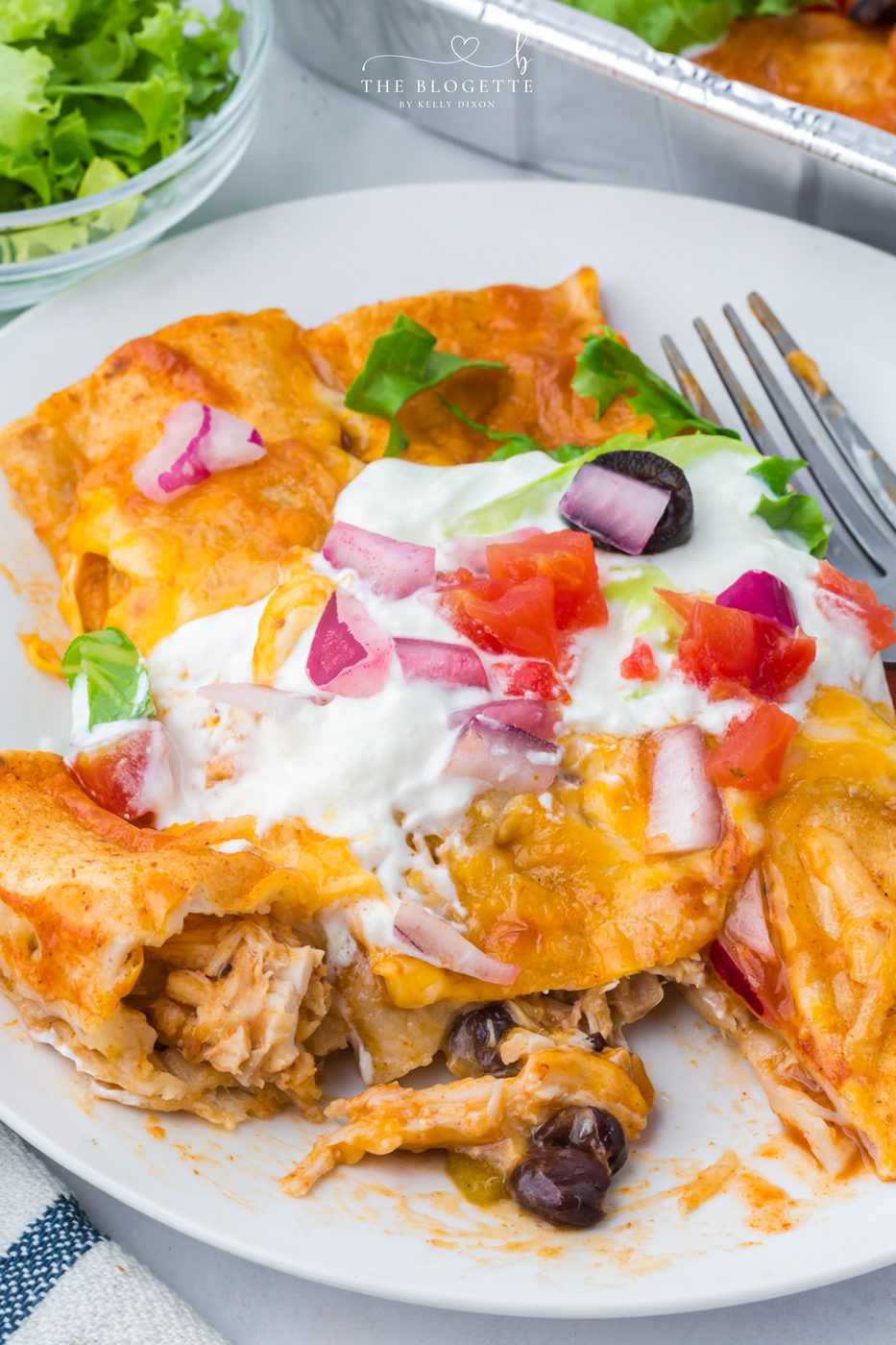 These Freezer Chicken Enchiladas make busy-night dinners so much easier! Crockpot chicken, black beans, green chiles, red enchilada sauce, and plenty of melted cheese come together in a recipe that makes TWO pans. Bake one tonight and freeze one for later!