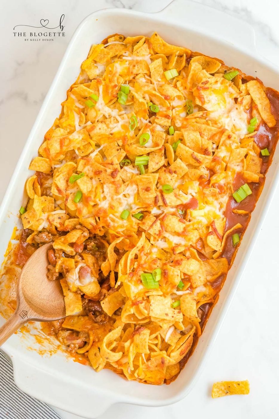 Frito Pie is a casserole made with ingredients like ground beef, taco seasoning, cheese, & Fritos. This can also make Walking Tacos!