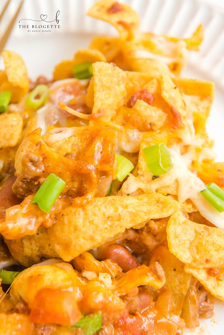 Frito Pie is a casserole made with ingredients like ground beef, taco seasoning, cheese, & Fritos. This can also make Walking Tacos!