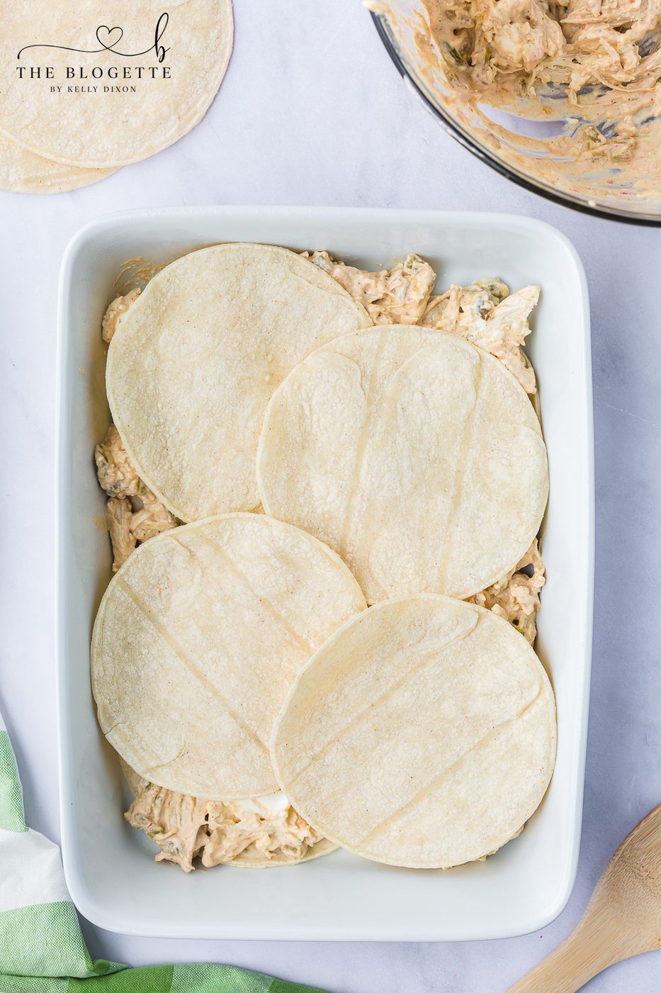 Place 4 corn tortillas on the bottom of the baking dish in a single layer.
