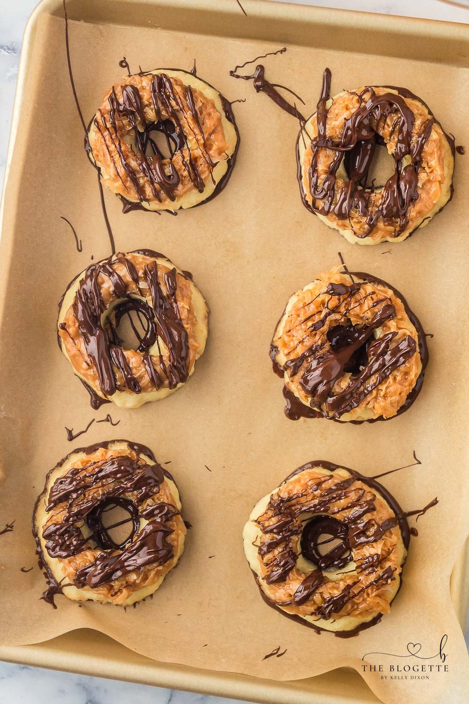 From-scratch Samoa Cookies are a at-home version of everyone's favorite Girl Scout Cookie! These big, thick, and buttery shortbread cookies melt in your mouth and are packed with chocolate, caramel, and coconut.