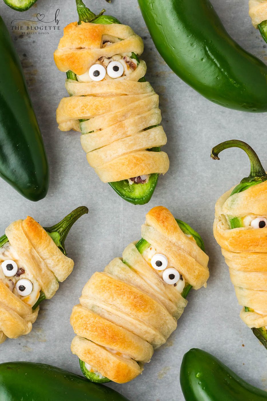Halloween Jalapeño Popper Mummies are adorably spooky jalapeños, filled with a cream cheese mixture, wrapped in crescent dough, and baked!