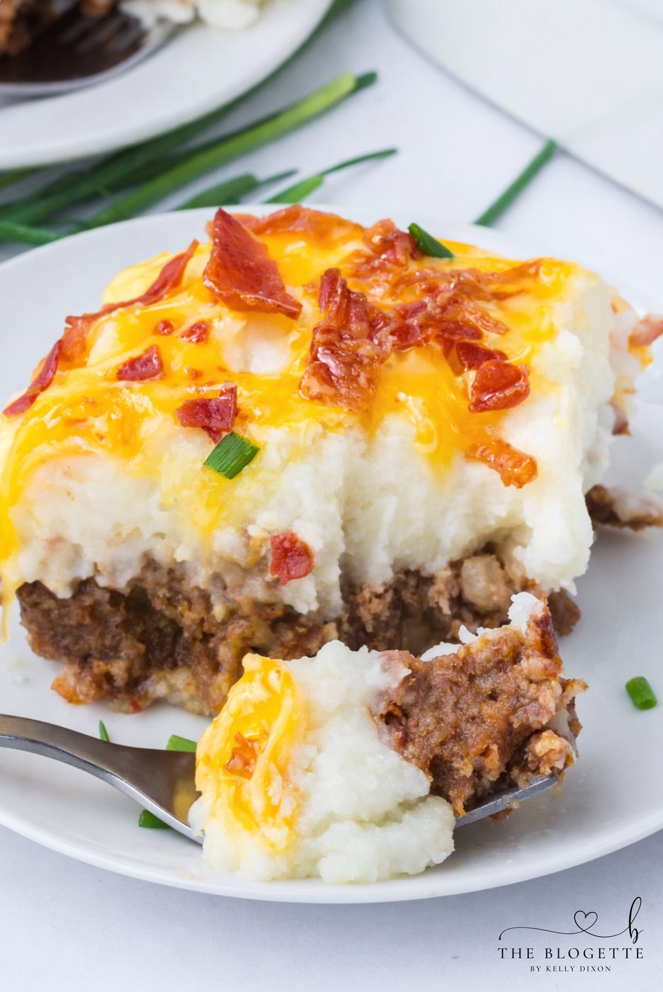 This Loaded Potato Meatloaf Casserole is the ultimate comfort food dinner. Layers of juicy meatloaf, creamy mashed potatoes, melted cheese, and crispy bacon make this straightforward casserole well-balanced for family dinners, meal prep, and freezer meals.