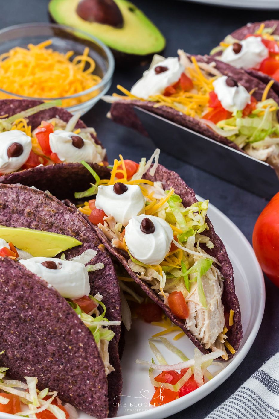 Monster Tacos for Halloween! These slow-cooker ranch chicken tacos feature blue corn taco shells and spooky sour cream eyes!
