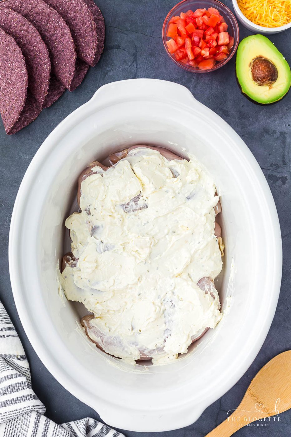 Cream, cream cheese, ranch seasoning, and taco seasoning over chicken