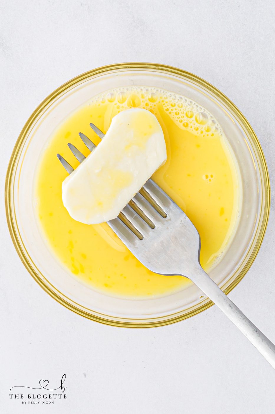 Dip the mozzarella slices in the egg