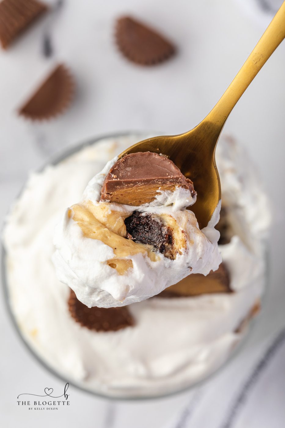 A favorite Peanut Butter Brownie Trifle recipe ever! Decadent layers of fudgy brownies and creamy peanut butter pudding studded with Reese’s peanut butter cups and topped with fluffy whipped cream.