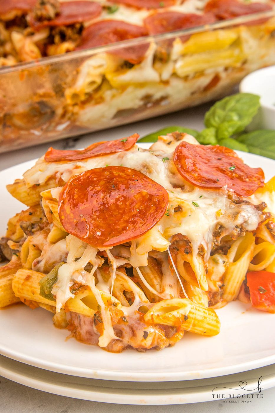 Pizza casserole has layers of pasta, sauce, and ooey-soft-centered cheese, along with your favorite pizza toppings.