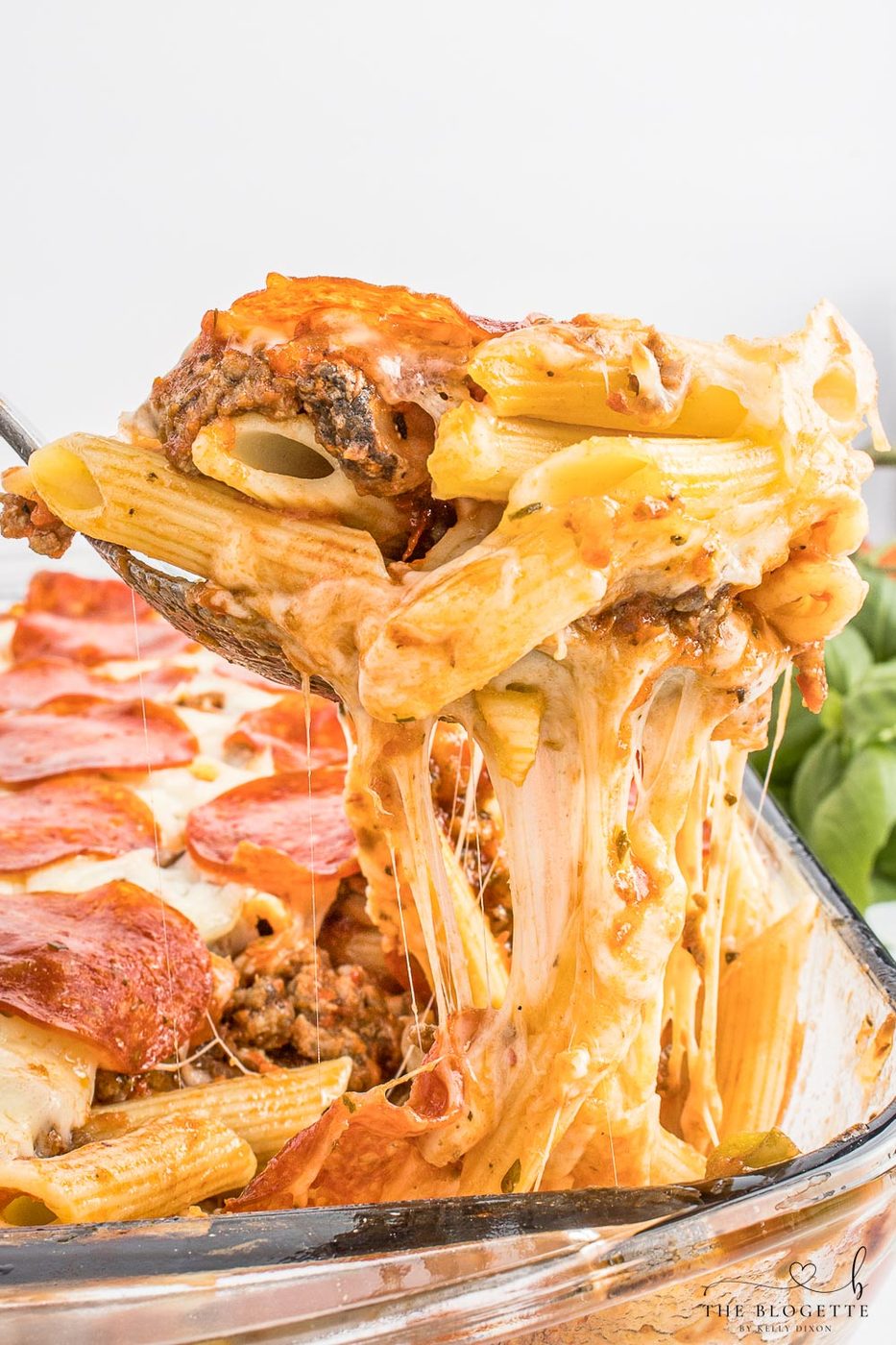 Pizza casserole has layers of pasta, sauce, and ooey-soft-centered cheese, along with your favorite pizza toppings.