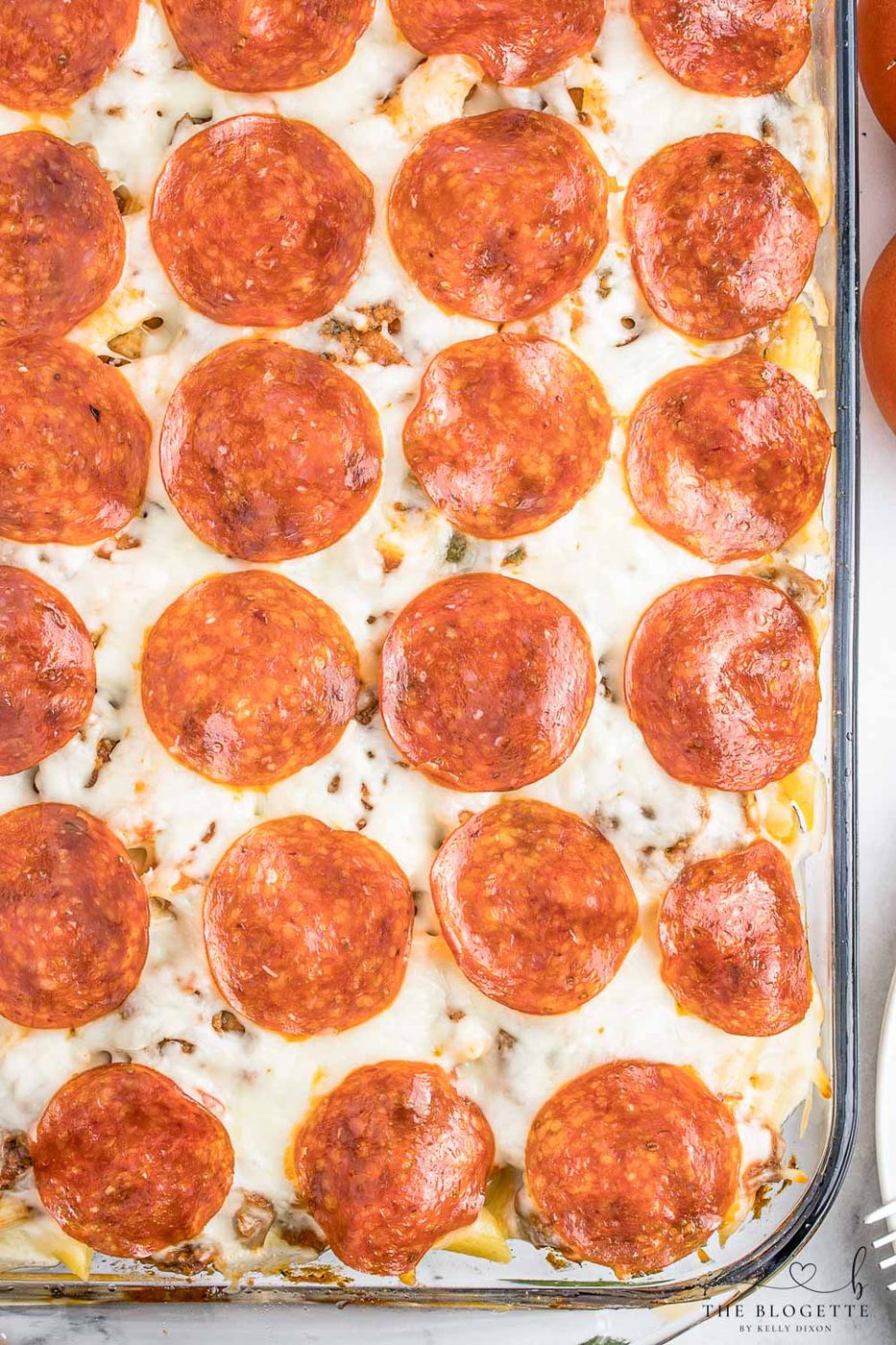 Pizza casserole has layers of pasta, sauce, and ooey-soft-centered cheese, along with your favorite pizza toppings.