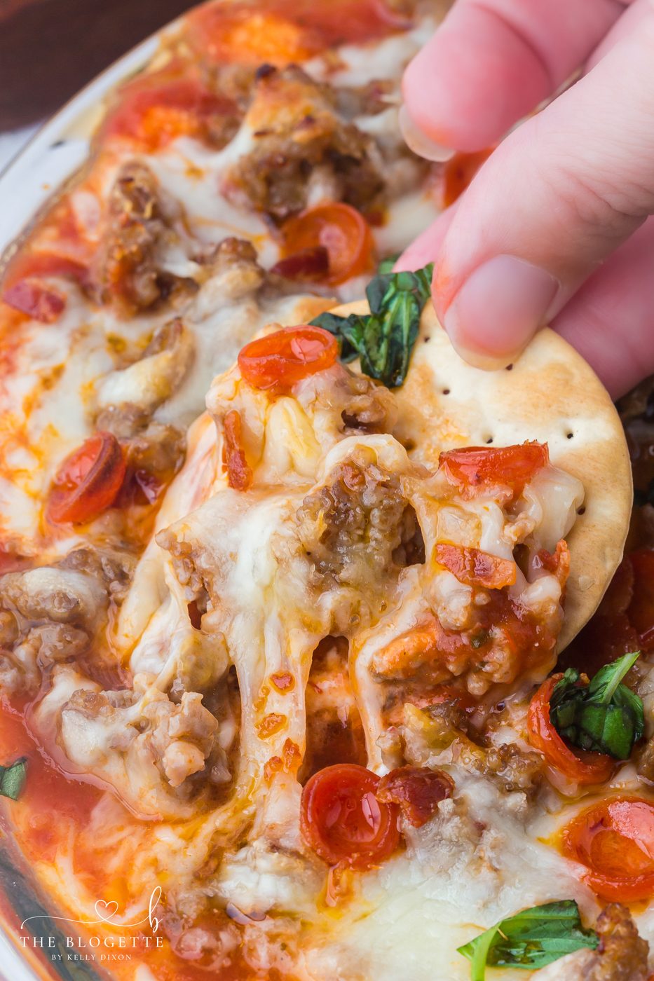 This straightforward Pizza Dip recipe is loaded with cream cheese, Italian sausage, mozzarella, and mini pepperonis for a soft-centered, crowd-pleasing appetizer everyone will love.