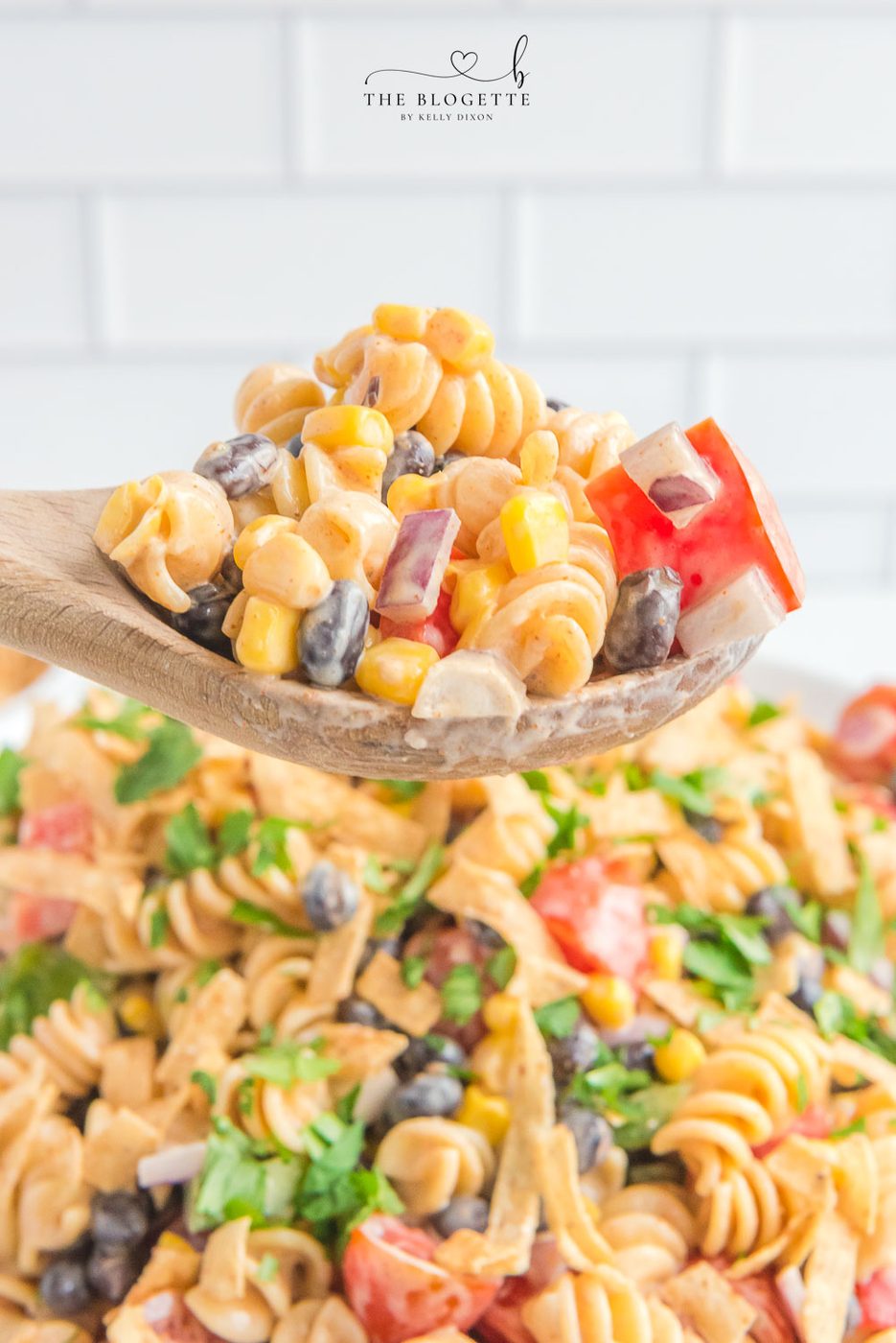 Creamy Ranch Taco Pasta Salad - Ranch dressing and taco seasoning folded into pasta with tomatoes, beans, corn, and more!