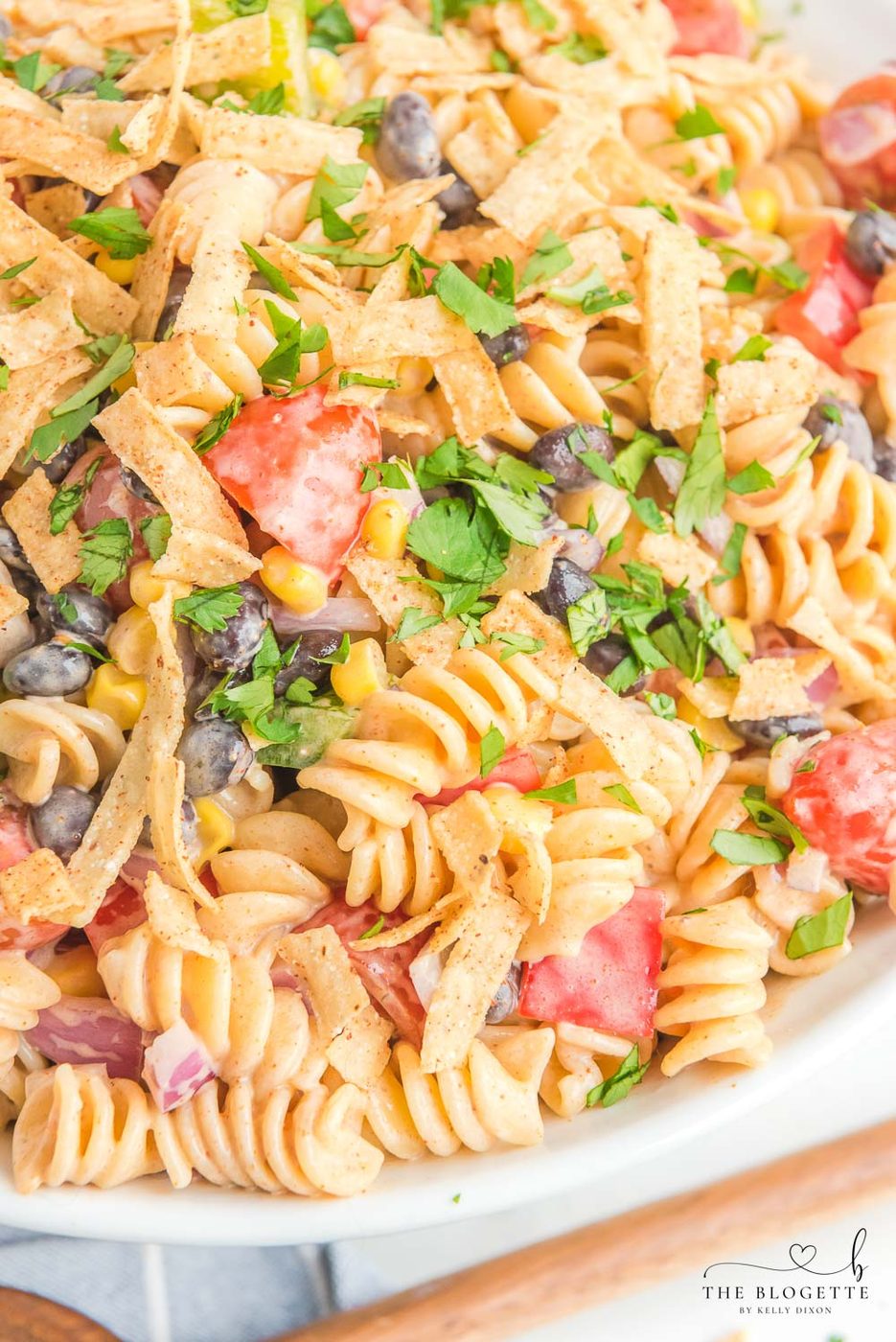 Creamy Ranch Taco Pasta Salad - Ranch dressing and taco seasoning folded into pasta with tomatoes, beans, corn, and more!