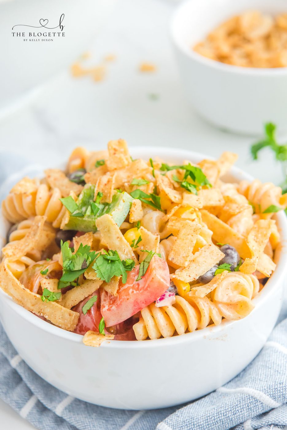 Creamy Ranch Taco Pasta Salad - Ranch dressing and taco seasoning folded into pasta with tomatoes, beans, corn, and more!