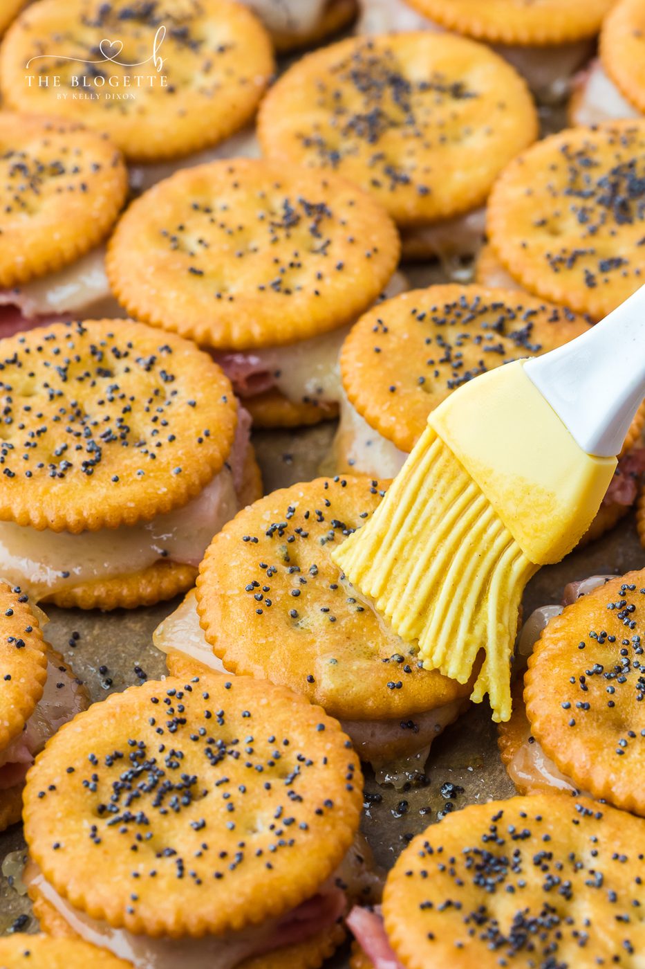 Brush the tops of the sandwiches with the melted butter