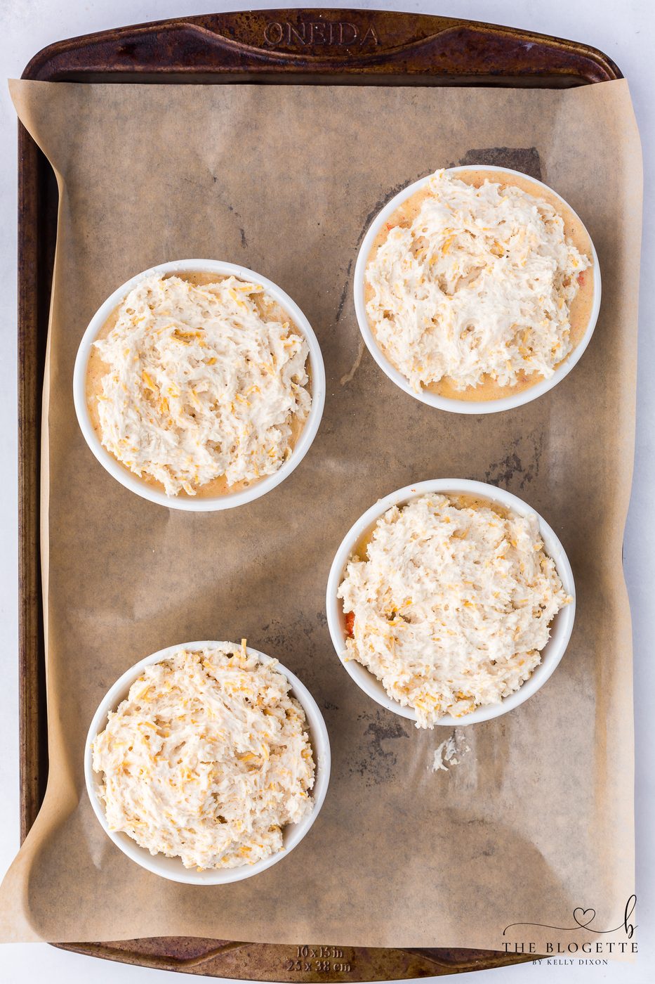 Top each ramekin with the Cheddar Bay biscuit dough