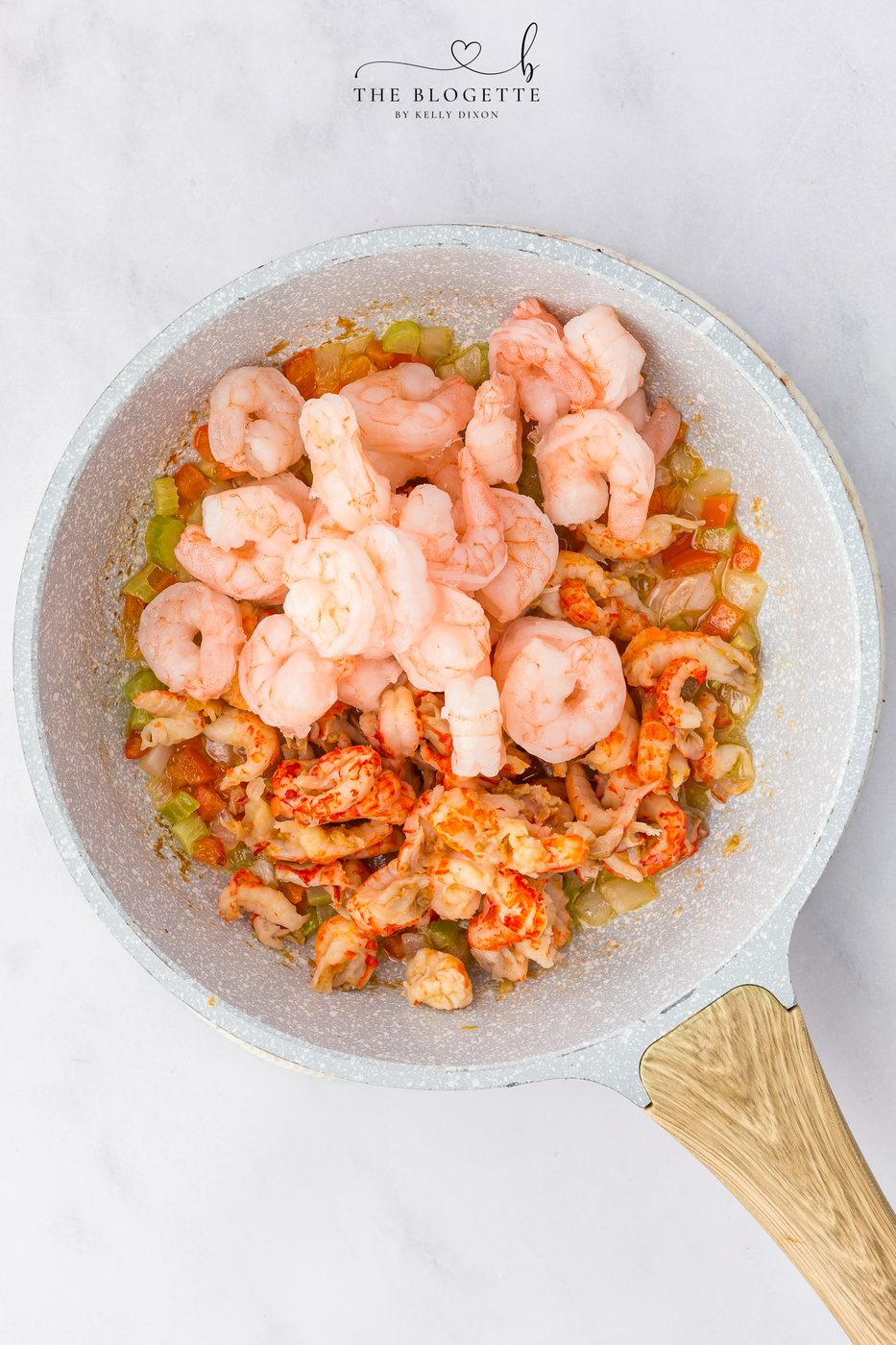 Season and add in the seafood to the veggies