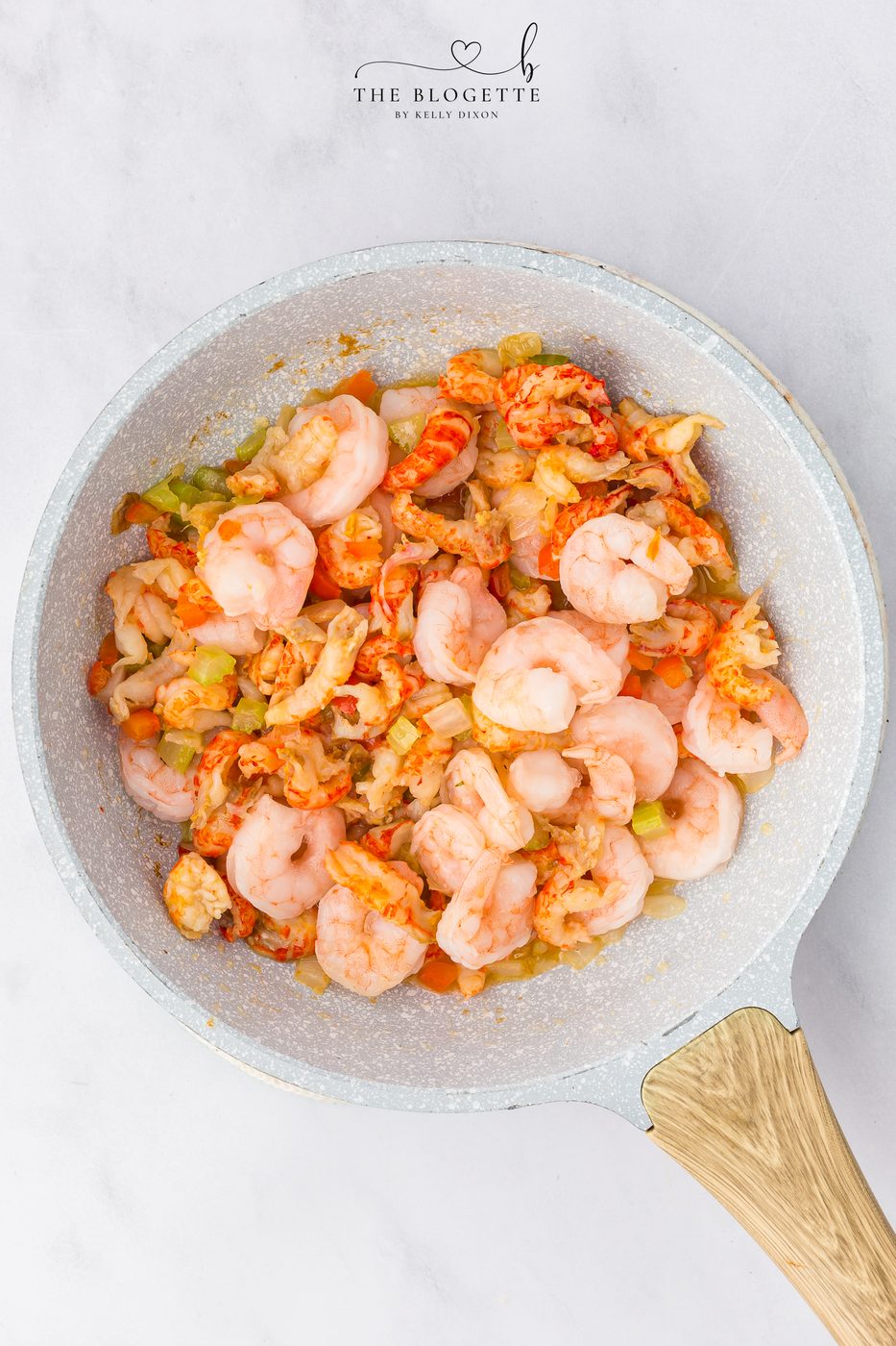 Season and add in the seafood to the veggies