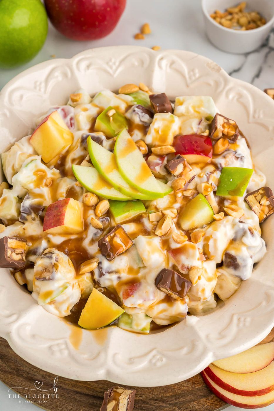 Snickers Apple Salad is a delightful dessert with a combination of apples and Snickers bars in a creamy white chocolate whipped cream sauce.