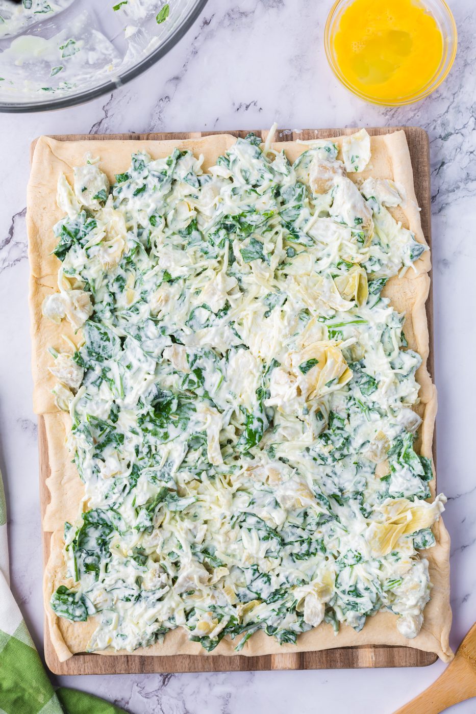 Spread the artichoke mixture over the crescent roll sheet