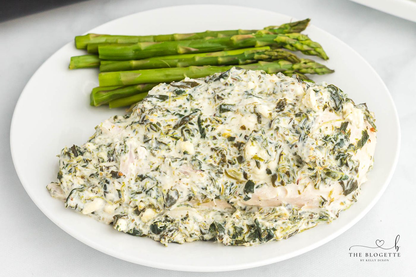 Spinach Dip Chicken Bake - Baked to perfection in 45 minutes! Creamy spinach cheese sauce smothered onto juicy chicken breasts.